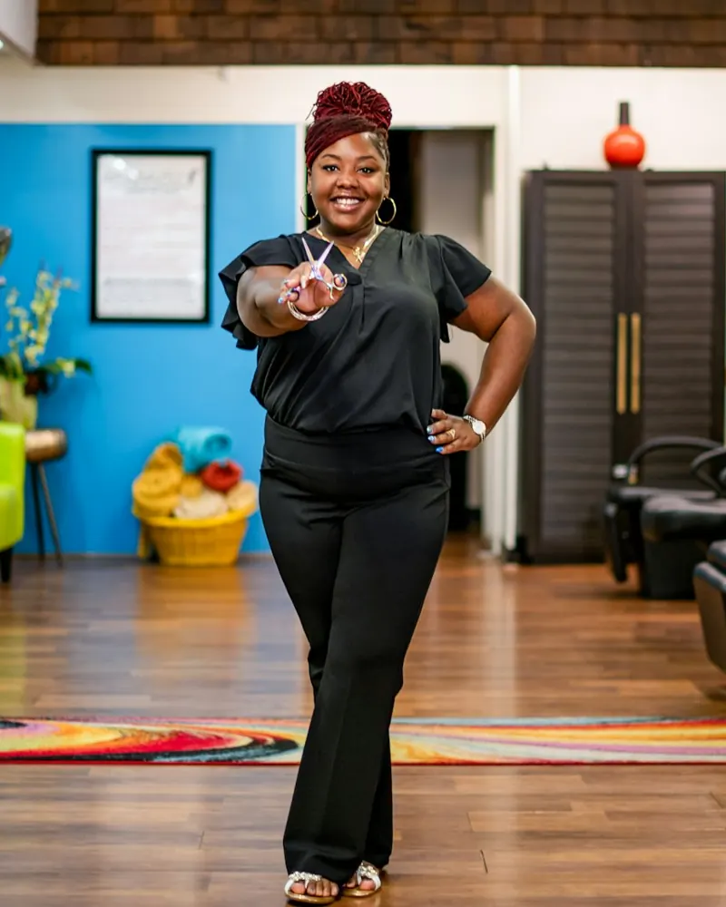 A salon owner smiling in her salon.